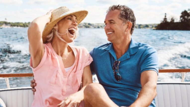 Couple sitting on a boat smiling